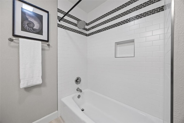 bathroom featuring tiled shower / bath