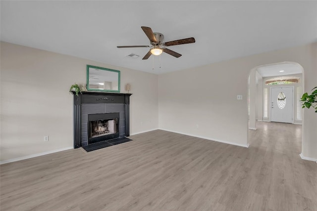 unfurnished living room featuring ceiling fan and light hardwood / wood-style floors