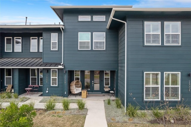 view of front of home with french doors and a patio