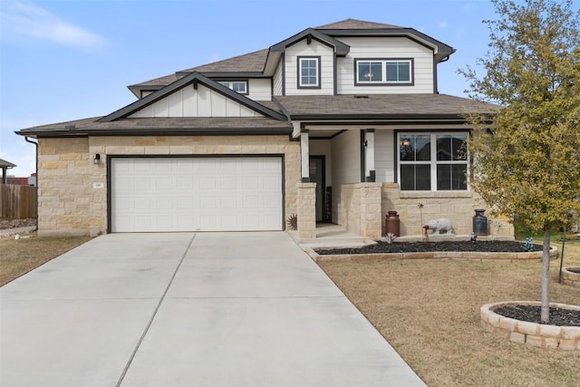 116 Big Cypress Bayou Rd, Hutto, TX 78634 - view of front facade with roof with shingles, stone siding, driveway, board and batten siding, and a garage
