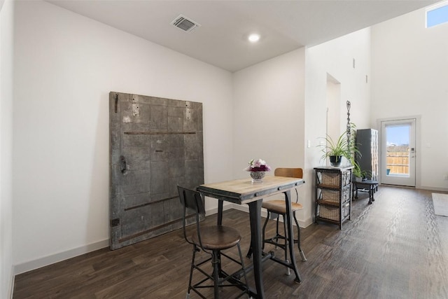 dining space featuring dark wood-type flooring