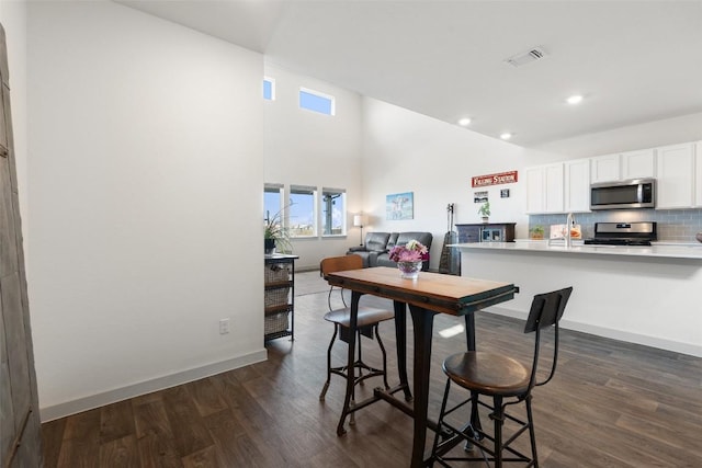 116 Big Cypress Bayou Rd, Hutto, TX 78634 - kitchen featuring appliances with stainless steel finishes, dark wood-style floors, white cabinets, light countertops, and recessed lighting
