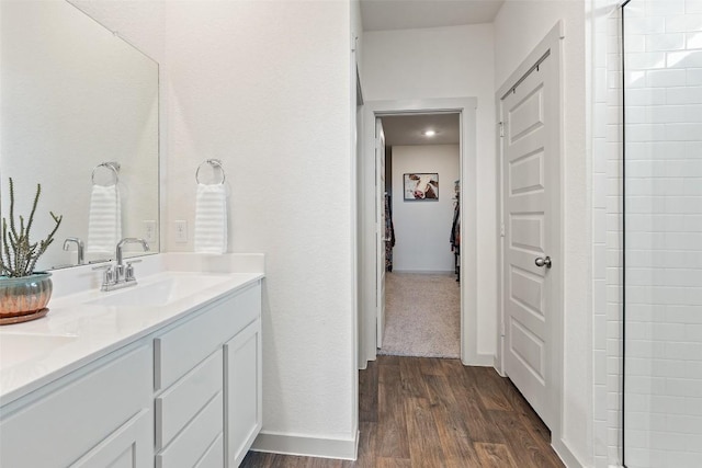 116 Big Cypress Bayou Rd, Hutto, TX 78634 - full bath featuring double vanity, wood finished floors, baseboards, and a shower