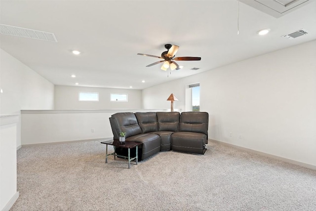 carpeted living room with ceiling fan