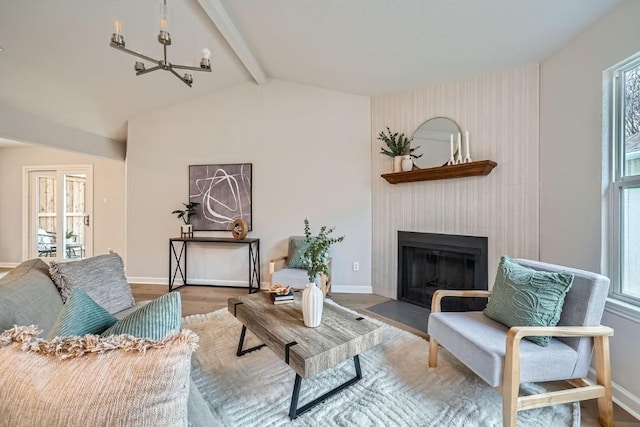 living room with wood-type flooring, a fireplace, and vaulted ceiling with beams