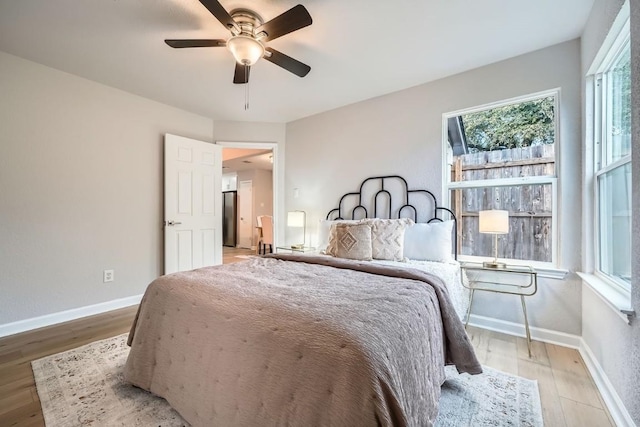 bedroom with hardwood / wood-style floors and ceiling fan