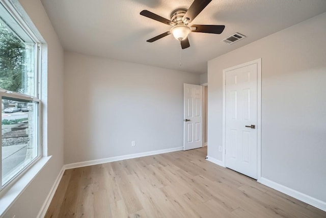 empty room featuring ceiling fan and light hardwood / wood-style floors