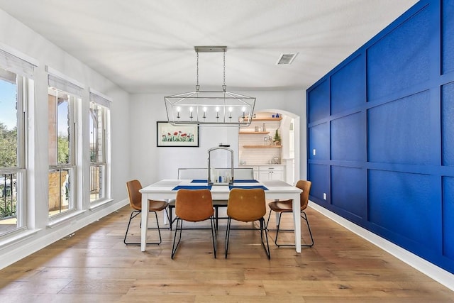 dining room with a notable chandelier and light hardwood / wood-style flooring