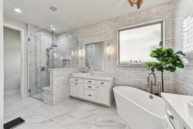 bathroom featuring shower with separate bathtub, tile walls, and vanity