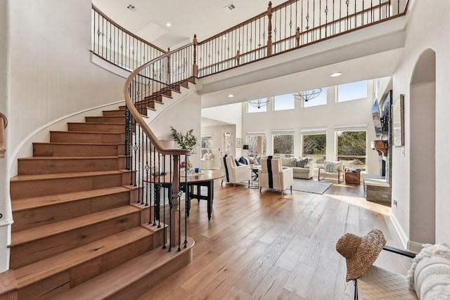 foyer featuring wood-type flooring and a high ceiling