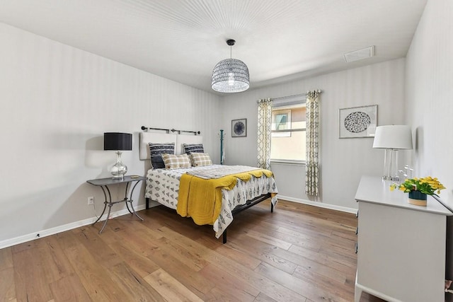 bedroom with hardwood / wood-style floors