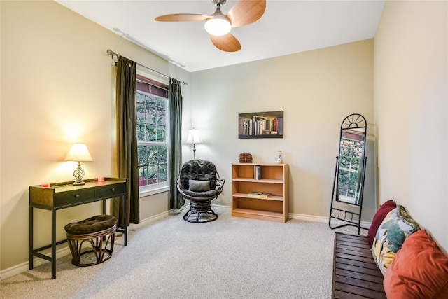 sitting room featuring ceiling fan and carpet flooring