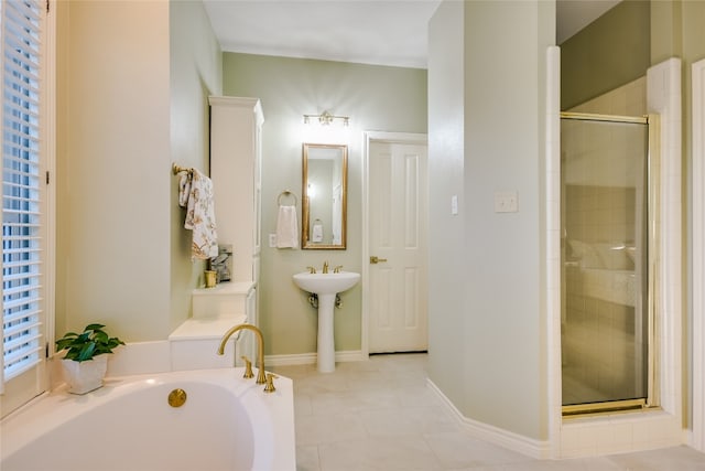 bathroom with independent shower and bath and tile patterned flooring