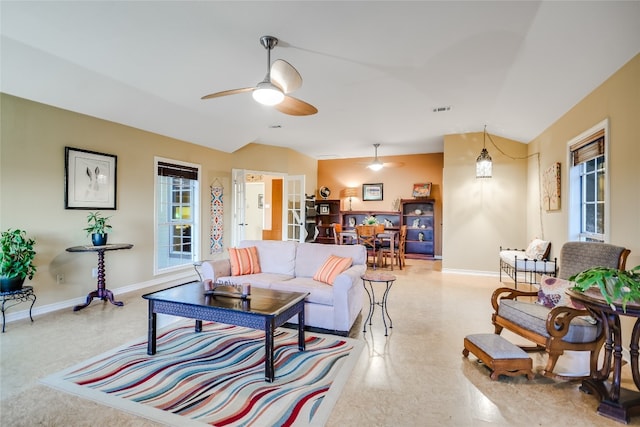 living room featuring ceiling fan and lofted ceiling