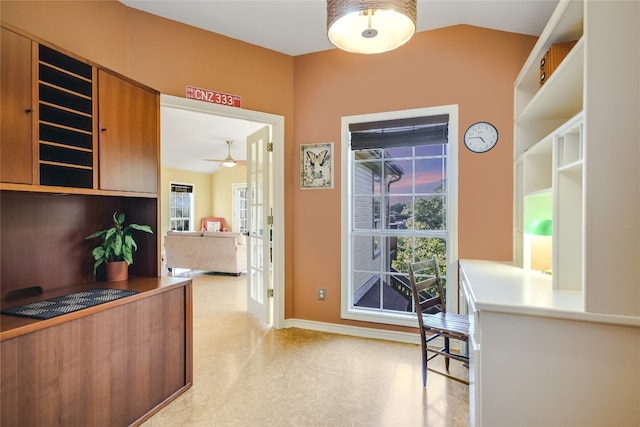 interior space with ceiling fan and french doors