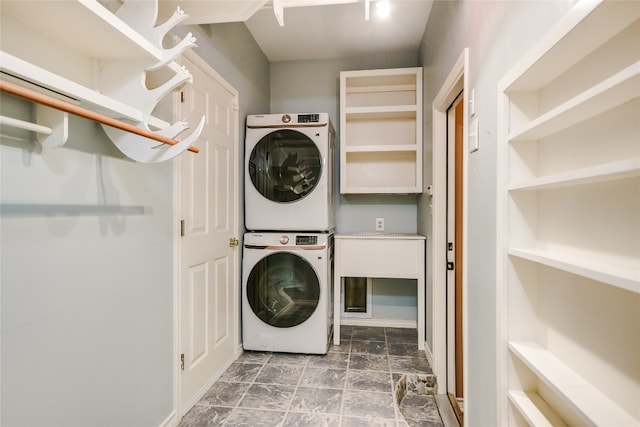 clothes washing area featuring stacked washer / drying machine