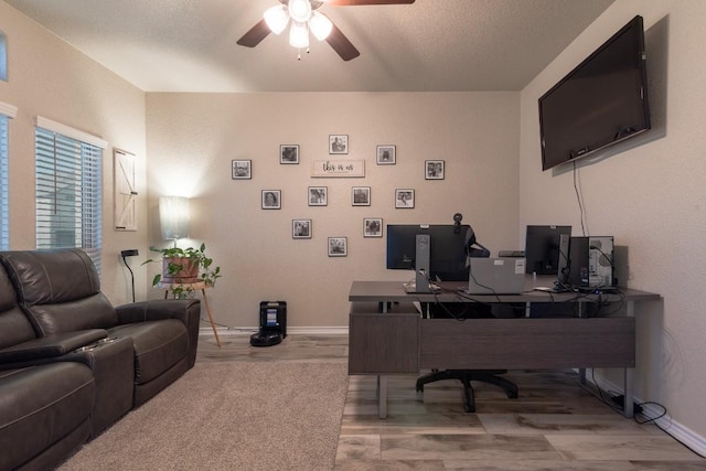 office area with hardwood / wood-style flooring, ceiling fan, and a textured ceiling