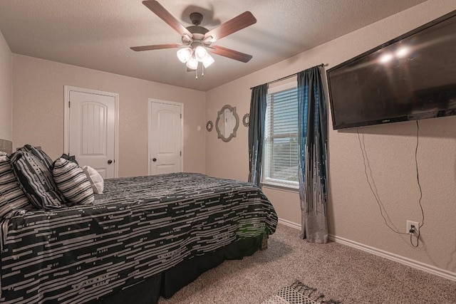 bedroom featuring ceiling fan, a textured ceiling, and carpet