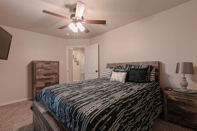 bedroom featuring carpet flooring, a textured ceiling, and ceiling fan