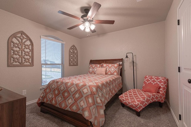 bedroom featuring ceiling fan, carpet floors, and a textured ceiling