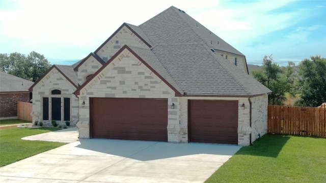 8000 Gold Dr, Killeen, TX 76542 - view of front of house with roof with shingles, driveway, stone siding, and an attached garage