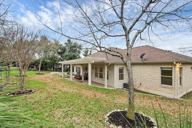 back of property featuring a yard, a pergola, and a patio area