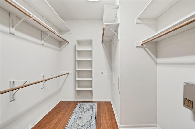 walk in closet with wood-type flooring