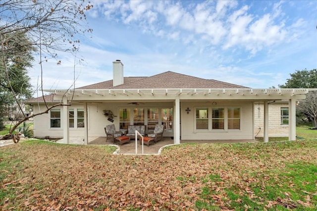 rear view of property featuring a patio area, a yard, and an outdoor hangout area