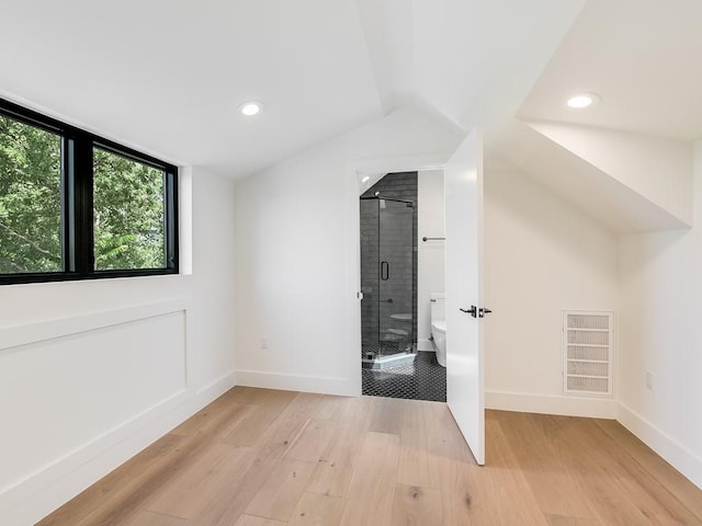 bonus room with vaulted ceiling and light hardwood / wood-style floors