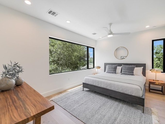 bedroom with ceiling fan and light hardwood / wood-style flooring