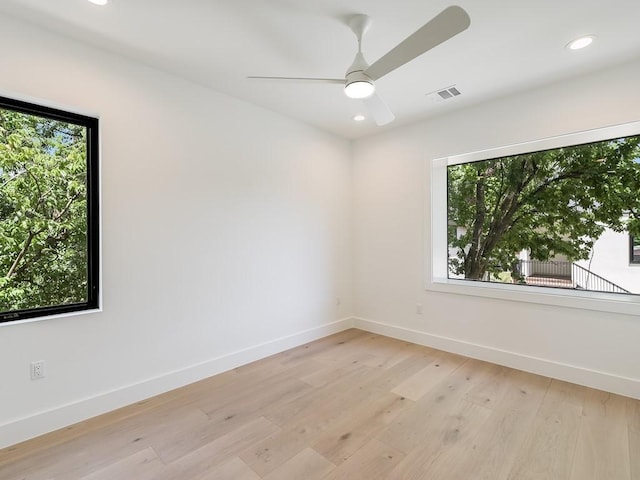 spare room with ceiling fan and light hardwood / wood-style flooring