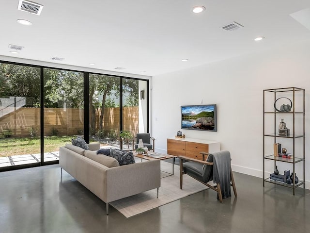 2903 E 14th St Unit 1, Austin, TX 78702 - living room with healthy amount of natural light, a wall of windows, baseboards, finished concrete flooring, and recessed lighting