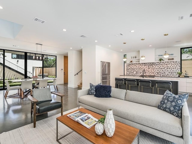 2903 E 14th St Unit 1, Austin, TX 78702 - living area featuring concrete flooring, stairs, recessed lighting, and baseboards