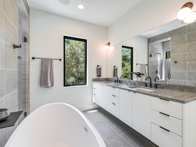 2903 E 14th St Unit 1, Austin, TX 78702 - full bath with double vanity, a freestanding bath, tile patterned floors, a stall shower, and recessed lighting