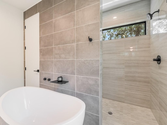 2903 E 14th St Unit 1, Austin, TX 78702 - full bathroom featuring a soaking tub, tiled shower, and tile walls