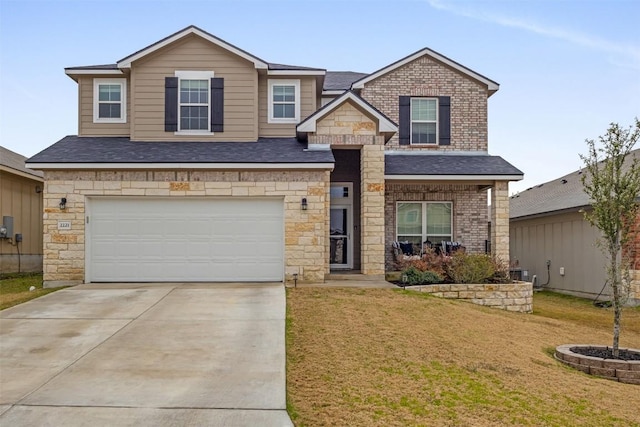 view of front of house featuring a garage and a front lawn