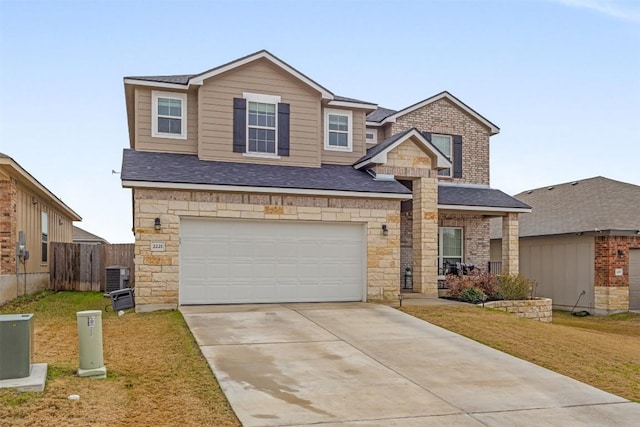 view of front of property featuring a garage, a front yard, and central air condition unit