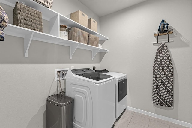 2221 Clove Ct, Temple, TX 76501 - clothes washing area with washer and clothes dryer and light tile patterned flooring