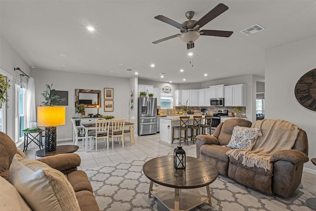 2221 Clove Ct, Temple, TX 76501 - living room with light tile patterned floors, a wealth of natural light, sink, and ceiling fan
