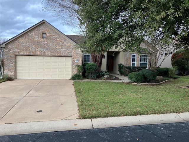 103 Wild Rose Dr, Georgetown, TX 78633 - view of front of property featuring concrete driveway, a garage, a front lawn, and brick siding