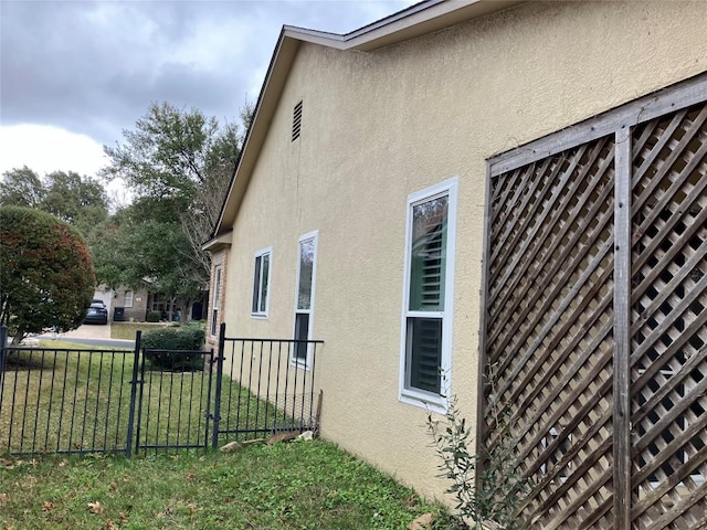 view of side of home with a lawn