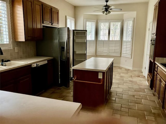 103 Wild Rose Dr, Georgetown, TX 78633 - kitchen featuring dishwasher, ceiling fan, a sink, decorative backsplash, and light countertops