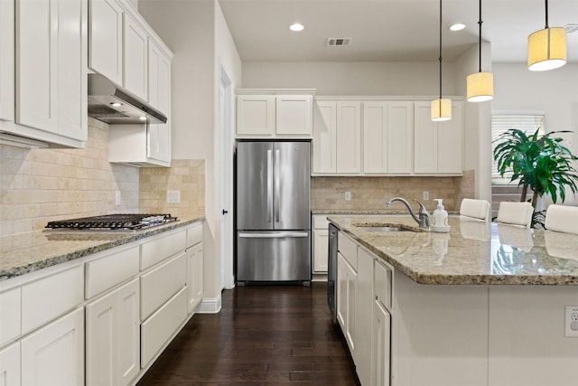 kitchen featuring sink, appliances with stainless steel finishes, white cabinetry, hanging light fixtures, and dark hardwood / wood-style floors