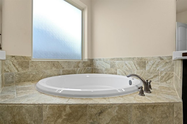 bathroom with a relaxing tiled tub