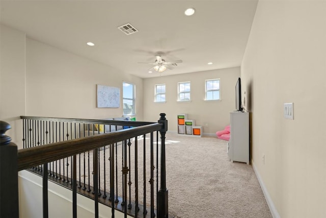 hallway featuring light carpet