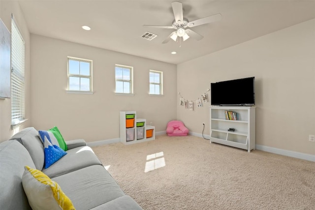 rec room featuring ceiling fan, a healthy amount of sunlight, and carpet