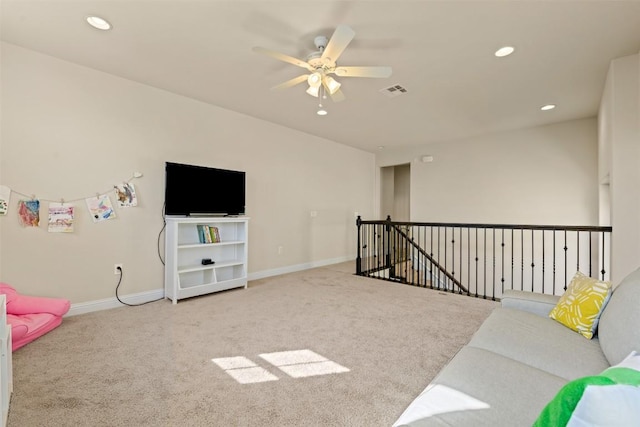 carpeted living room with ceiling fan