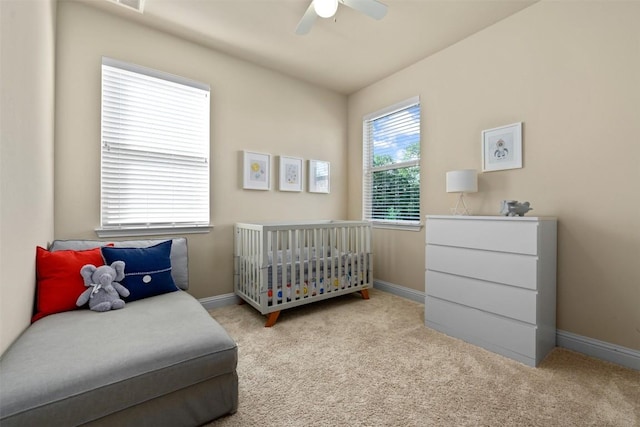 bedroom featuring light colored carpet and ceiling fan