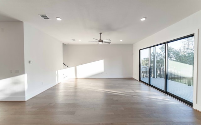 empty room with hardwood / wood-style flooring and ceiling fan