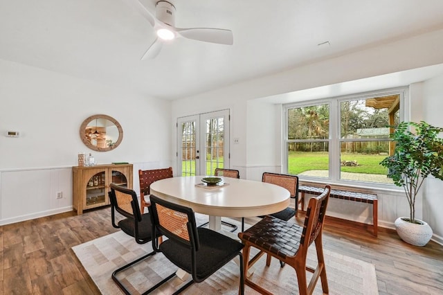 dining area with french doors, ceiling fan, wood-type flooring, and radiator heating unit